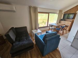 a living room with a couch and a table at Angela Apartment in Mavrovo