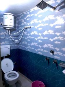 a bathroom with a blue wall with fish on it at HOTEL SAMRAT PALACE in Ayodhya