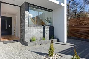 a house with a glass door on the side of it at Modern Sandy Bay Apt - Close to Salamanca & CBD in Sandy Bay