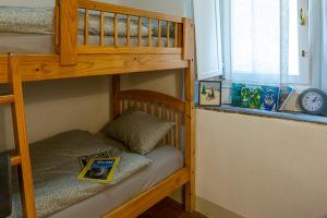 a bedroom with two bunk beds with a book at Fiordaliso Apartment in Como