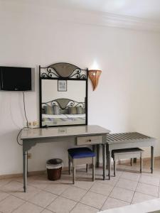 a dressing table with a bench and a mirror at Hotel Diar Yassine in Midoun