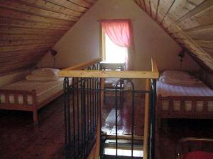 a attic room with two bunk beds and a window at Sydöstra Gotland in Hemse