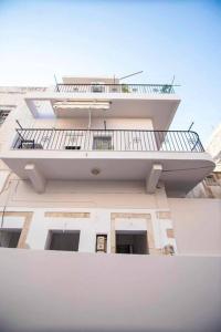 a building with a balcony on top of it at Ammoudara Apartment's in Kalymnos