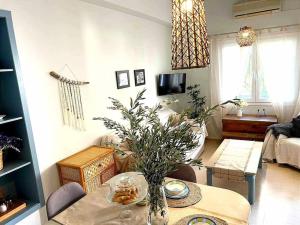 a living room with a table and a couch at Ammoudara Apartment's in Kalymnos
