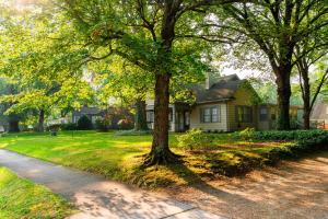 a house with trees in front of a yard at Beautiful Home in Historic Downtown Norcross in Norcross