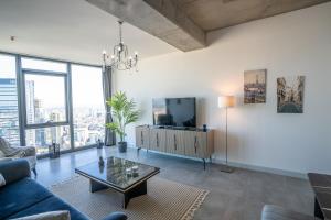 a living room with a couch and a tv at City View Apt - Panoramic Views Of The City in Istanbul