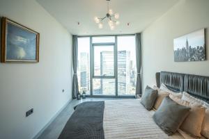 a bedroom with a bed with a large window at City View Apt - Panoramic Views Of The City in Istanbul