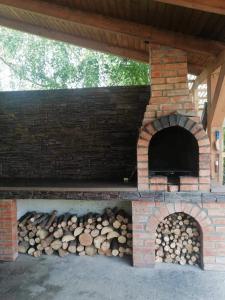 a brick oven with a pile of logs in it at Casa PICY Vendégház in Sovata