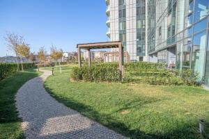 a grassy area next to a building with a sidewalk at City View Apt - Panoramic Views Of The City in Istanbul