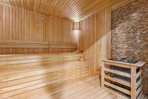 a sauna with wooden floors and a brick wall at Ramada by Wyndham Istanbul Umraniye in Istanbul