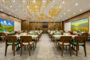 a conference room with tables and chairs and chandeliers at Ramada by Wyndham Istanbul Umraniye in Istanbul