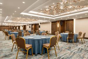 a conference room with tables and chairs and a podium at Ramada by Wyndham Istanbul Umraniye in Istanbul