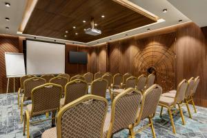 a conference room with chairs and a wall of wood at Ramada by Wyndham Istanbul Umraniye in Istanbul