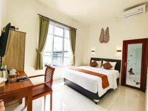 une chambre avec un lit, un bureau et un ordinateur dans l'établissement The Tunjung Boutique Resort, à Dalung 62 autres photos