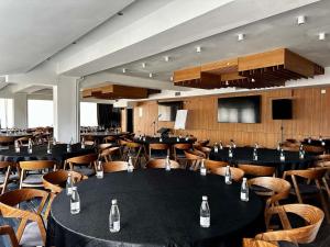 a dining room with tables and chairs with bottles at LAKEVIEW Hotel & Apartments in Mavrovo +49 photos