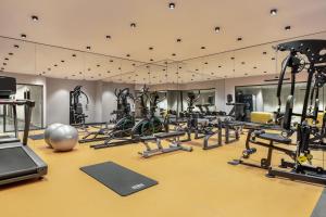 a gym with a lot of treadmills and machines at Ramada by Wyndham Istanbul Umraniye in Istanbul