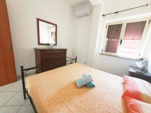 A bed or beds in a room at Casa di Vacanza Marina di Davoli