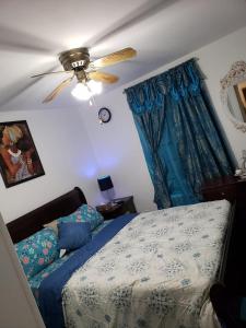 a bedroom with a bed and a ceiling fan at Comfortable holiday homestay in Bronx