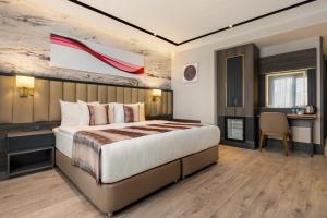 a hotel room with a bed and a desk at Ramada by Wyndham Istanbul Umraniye in Istanbul +25 photos