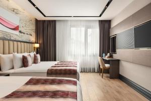 a hotel room with a bed and a flat screen tv at Ramada by Wyndham Istanbul Umraniye in Istanbul