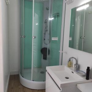 a bathroom with a glass shower and a sink at BELLA - chez Florence , chambres d'hôtes, Montrol Sénard in Montrol-Sénard