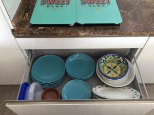 a drawer filled with bowls and plates on a shelf at Mojácar Vibes 1 Línea de Playa in Mojácar