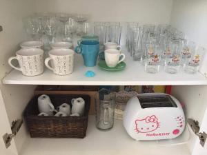 a shelf filled with glasses and a toaster and cups at Mojácar Vibes 1 Línea de Playa in Mojácar