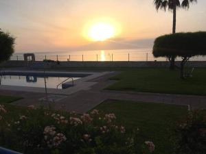 a sunset over a park with a bench and the ocean at Mojácar Vibes 1 Línea de Playa in Mojácar