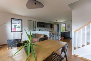 a dining room and living room with a wooden table at GuestReady - Elegant Bègles Getaway in Bègles