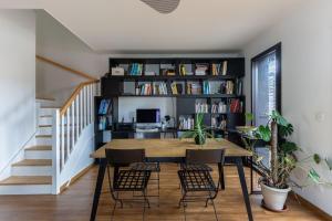 a dining room with a table and chairs and a book shelf at GuestReady - Elegant Bègles Getaway in Bègles