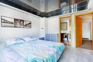 a bedroom with a bed and a flat screen tv at Bargkass - Vue montagne et piscine in La Bresse +15 photos