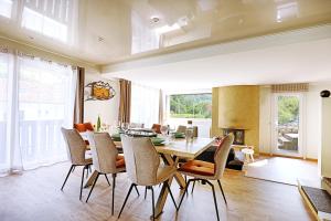 a dining room with a table and chairs at Bargkass - Vue montagne et piscine in La Bresse