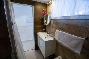 a bathroom with a sink and a mirror at Chaparal Design Apartment in Costa Del Silencio
