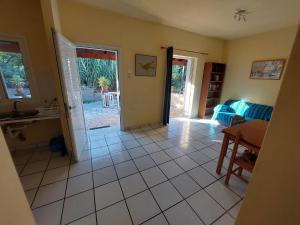 a kitchen and living room with a table and a door at Kidonakia Apartments in Agios Ioannis