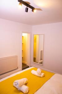 a bedroom with a bed with two towels on it at Ideal Contractors 3 Double Bedrooms Near Gloucester Quays and Parking in Hempstead