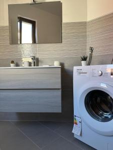 uma casa de banho com uma máquina de lavar roupa e um lavatório em Lux Domus em Montoro Inferiore