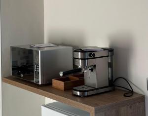 a coffee machine sitting on a wooden shelf at Lux Domus in Montoro Inferiore