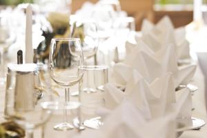 a table with wine glasses and napkins on it at Gasthof zur Post in Sankt Kathrein am Hauenstein