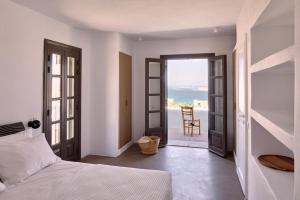 a bedroom with a bed and a view of the ocean at Platinum Paros Villa - Villa Azure - 5 Bedrooms - Sea Views & Private Pool - Naoussa in Kolympithres