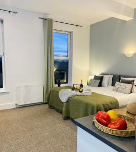 a hotel room with two beds and a table with a bowl of fruit at Martello Hotel in Hull