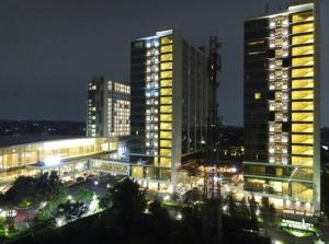 two tall buildings in a city at night at Lavenderbnb Room 6 at Mataram City in Yogyakarta