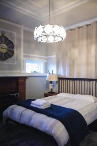 a bedroom with a large bed with a clock on the wall at Cozy BoxHill - Modern Stylish Share House in Box Hill