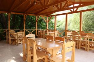 a dining room with a wooden table and chairs at Yenokyans' Riverside Hotel in Areni