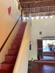 a staircase in a building with a stair case at Pangani Cliffs Lodge in Pangani