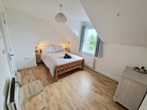 a bedroom with a bed and a window at GlenVista Holiday Accommodation in Glenariff