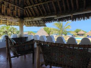 a view of the beach from a resort with chairs at Pangani Cliffs Lodge in Pangani