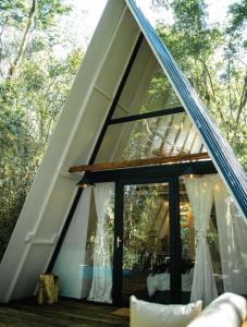 a frame house with a large window at Salto Suizo Parque Ecologico in Independencia