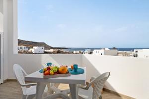 a white table with a bowl of fruit on it at Viviendas El Pescador - Ancla in El Golfo