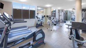 a gym with several treadmills and cardio machines at Modern and Cosy Sydney CBD Studio in Central in Sydney