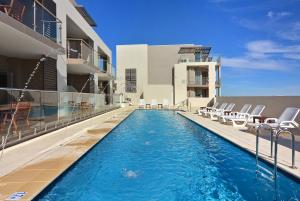 a swimming pool on the side of a building at Bunbury Seaview Apartments in Bunbury